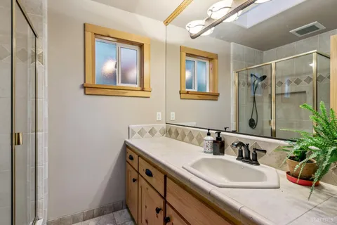 a bathroom with a tub a sink and mirror