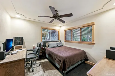 a bedroom with a bed and a desk