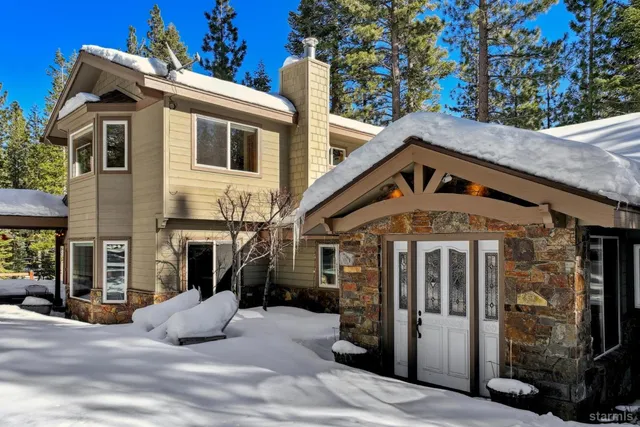 a front view of a house with a yard porch and outdoor seating