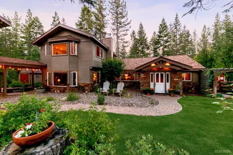 a front view of a house with yard and green space