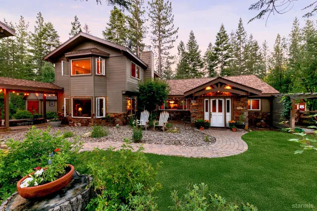 a front view of a house with yard and green space