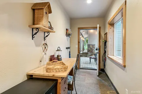 a view of a dining room with furniture and a window
