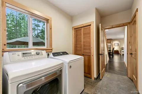 a view of a storage and utility room with washer and dryer