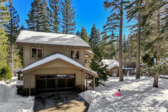 a front view of a house with yard and green space