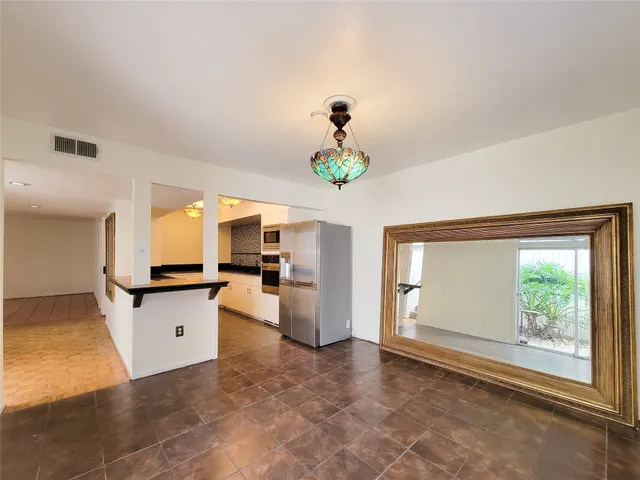 a kitchen with a refrigerator and a stove