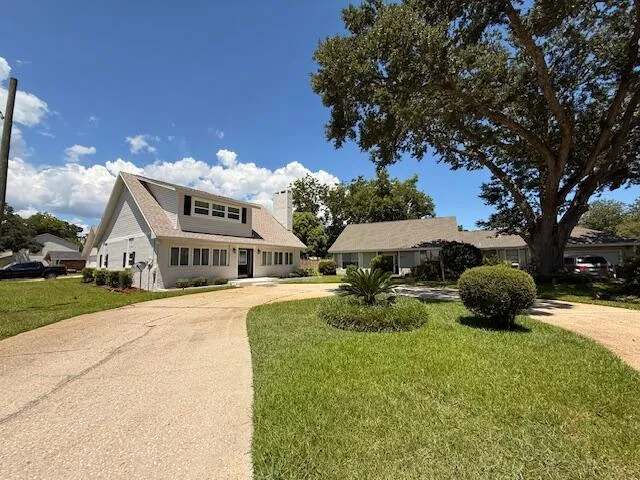 a front view of a house with yard and garage