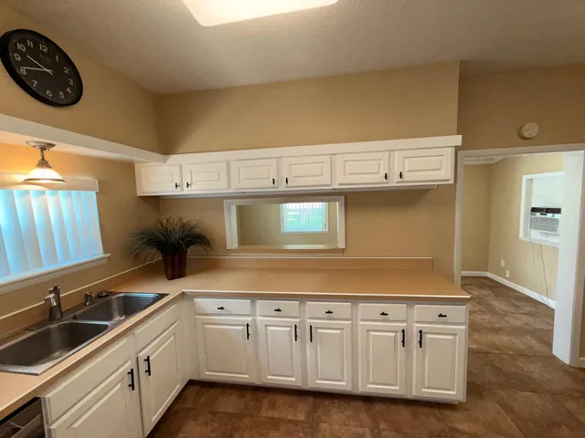 a kitchen with a refrigerator sink and stove