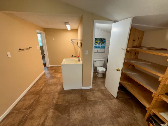 a view of a room with wooden floor and staircase