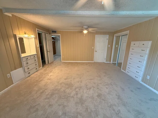 a house view with garden space and trees