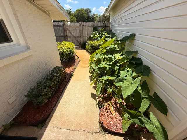 a view of building with river and trees in the background