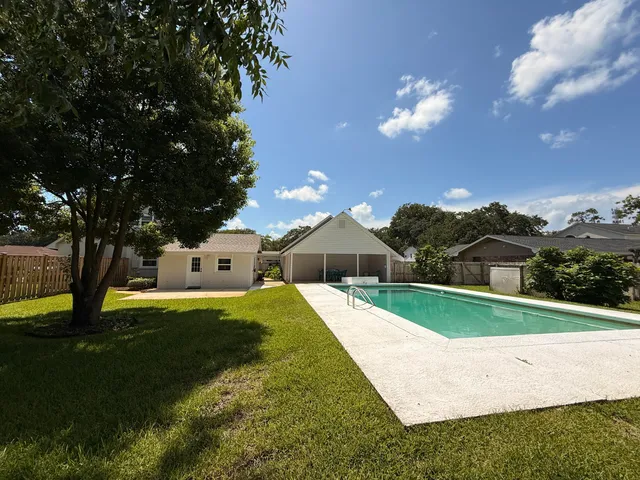 a house with swimming pool in front of it