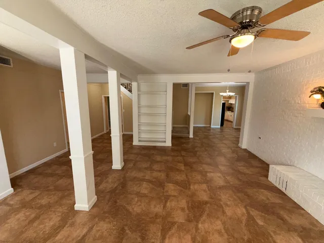 a kitchen with a refrigerator sink and cabinets