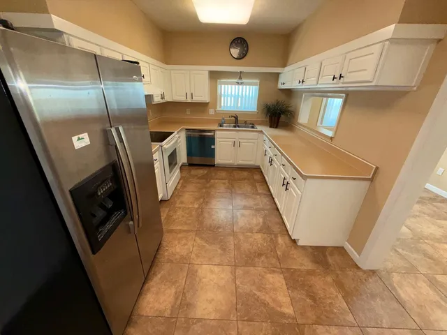 a kitchen with a stove top oven and refrigerator