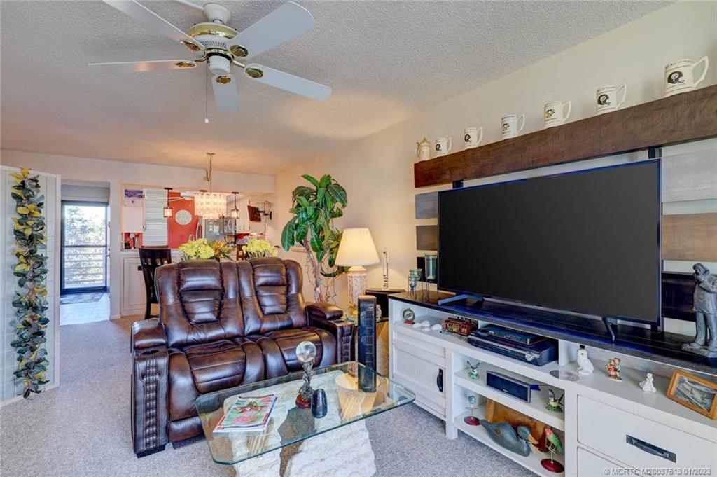 1950 Southwest Palm City Road, Unit 5306 Stuart, FL 34994 - Photo 12 of 55 a room with furniture and flat screen tv