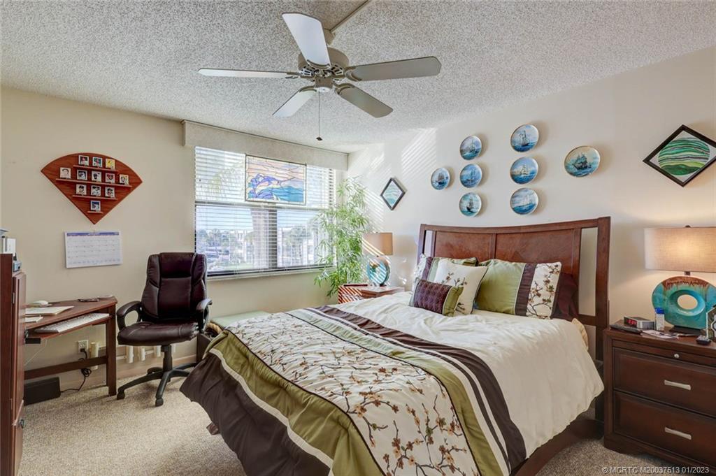1950 Southwest Palm City Road, Unit 5306 Stuart, FL 34994 - Photo 21 of 55 a bedroom with a bed and a window