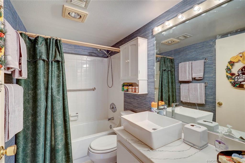 1950 Southwest Palm City Road, Unit 5306 Stuart, FL 34994 - Photo 28 of 55 a bathroom with a toilet a sink and a large mirror