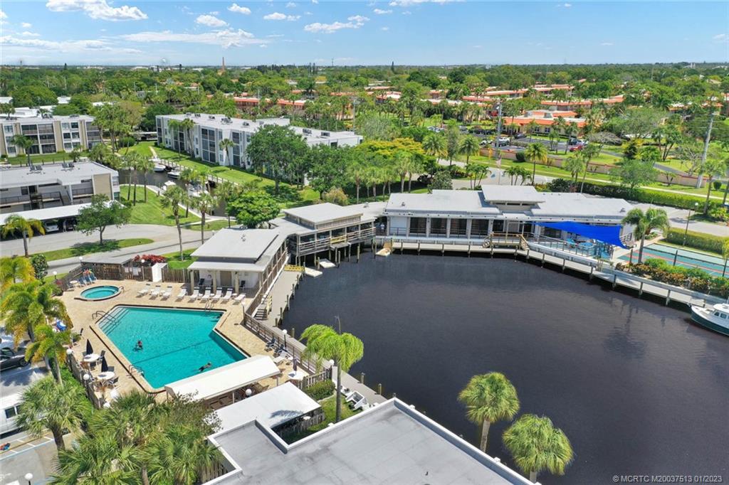 1950 Southwest Palm City Road, Unit 5306 Stuart, FL 34994 - Photo 52 of 55 an aerial view of a house with a garden and lake view