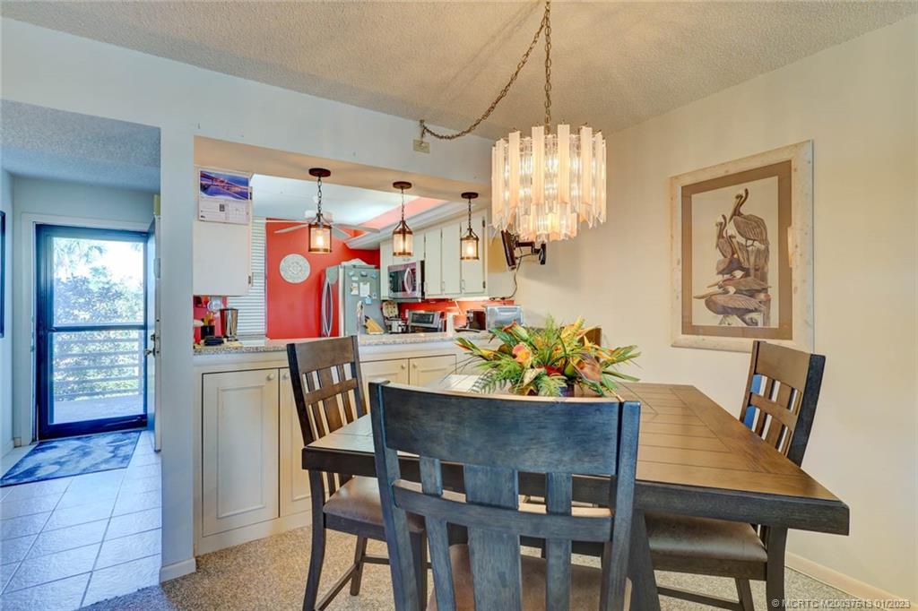 1950 Southwest Palm City Road, Unit 5306 Stuart, FL 34994 - Photo 10 of 55 a view of a dining room with furniture and chandelier