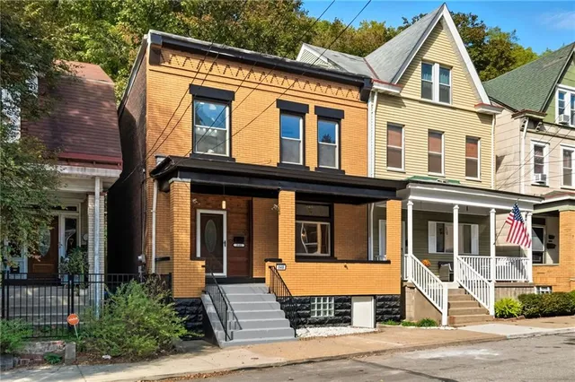 a front view of a house with a yard