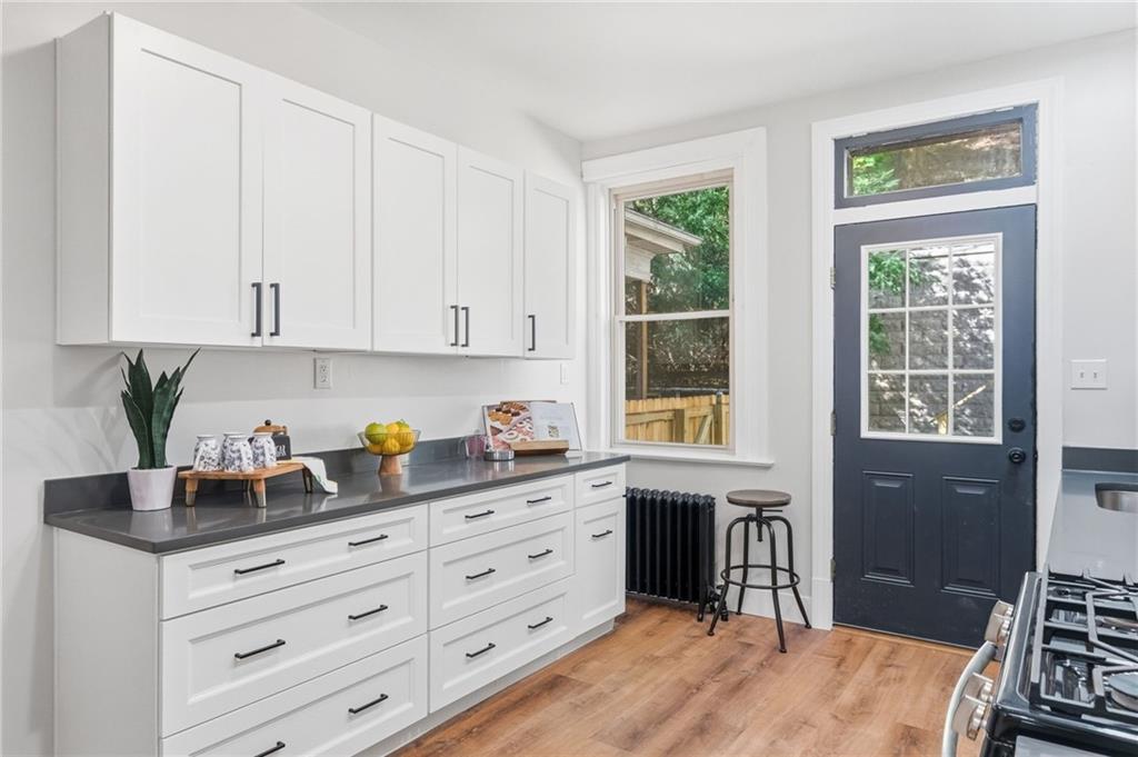 848 Grand Avenue Pittsburgh, PA 15212 - Photo 15 of 33 a kitchen with granite countertop a stove a sink and a cabinets