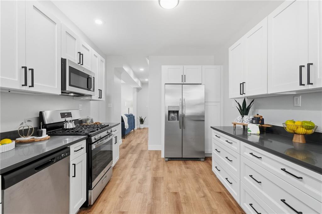 848 Grand Avenue Pittsburgh, PA 15212 - Photo 16 of 33 a kitchen with stainless steel appliances a stove cabinets sink and refrigerator