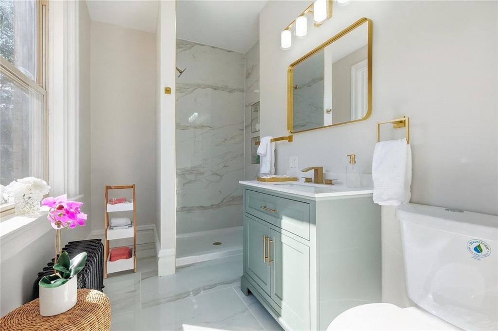 848 Grand Avenue Pittsburgh, PA 15212 - Photo 21 of 33 a bathroom with a sink vanity mirror and toilet