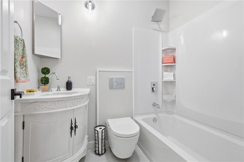 848 Grand Avenue Pittsburgh, PA 15212 - Photo 26 of 33 a bathroom with a sink a toilet and shower