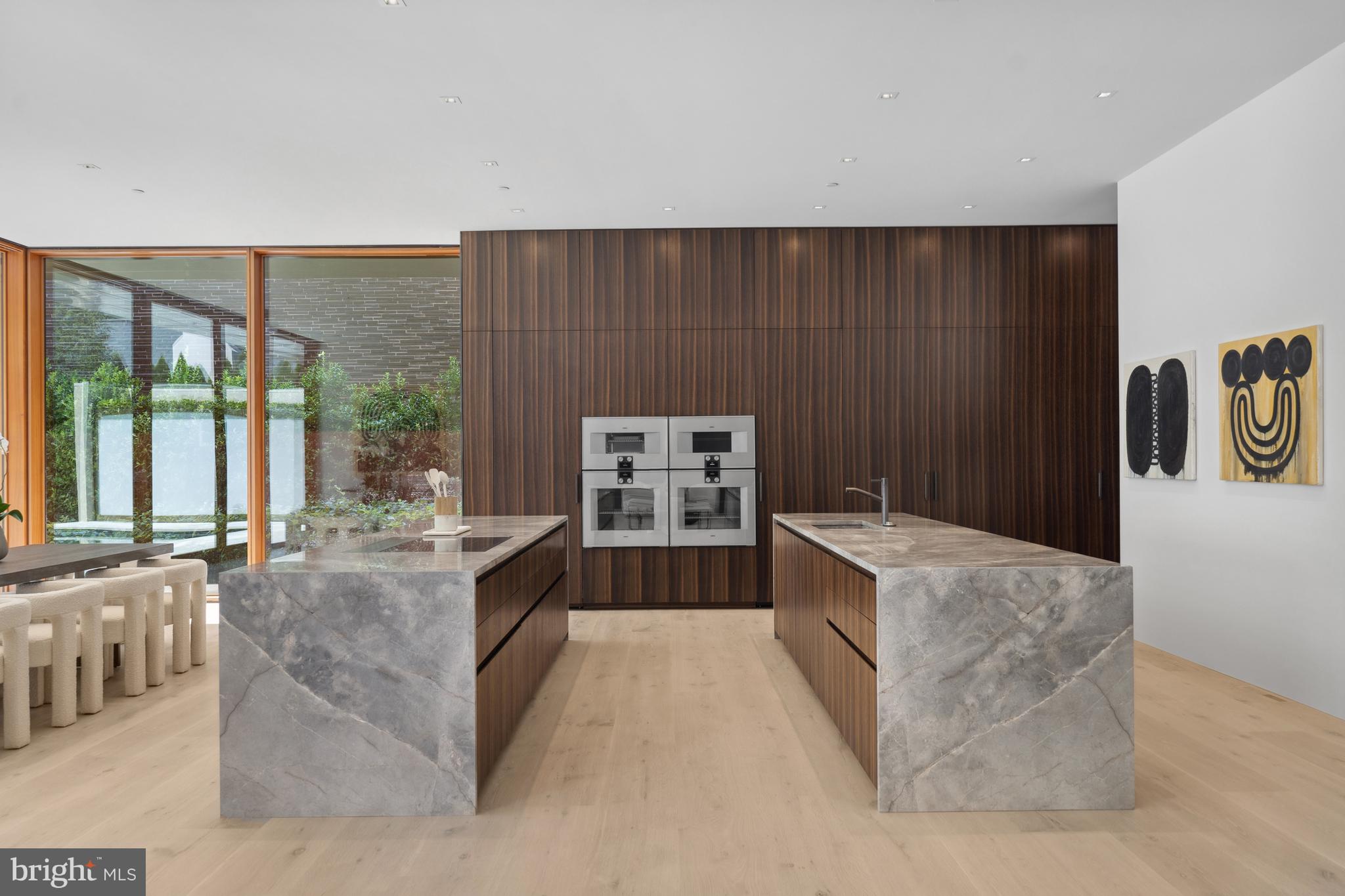 3131 Chain Bridge Road Northwest Washington, DC 20016 - Photo 12 of 54 a kitchen with granite countertop a stove top oven
