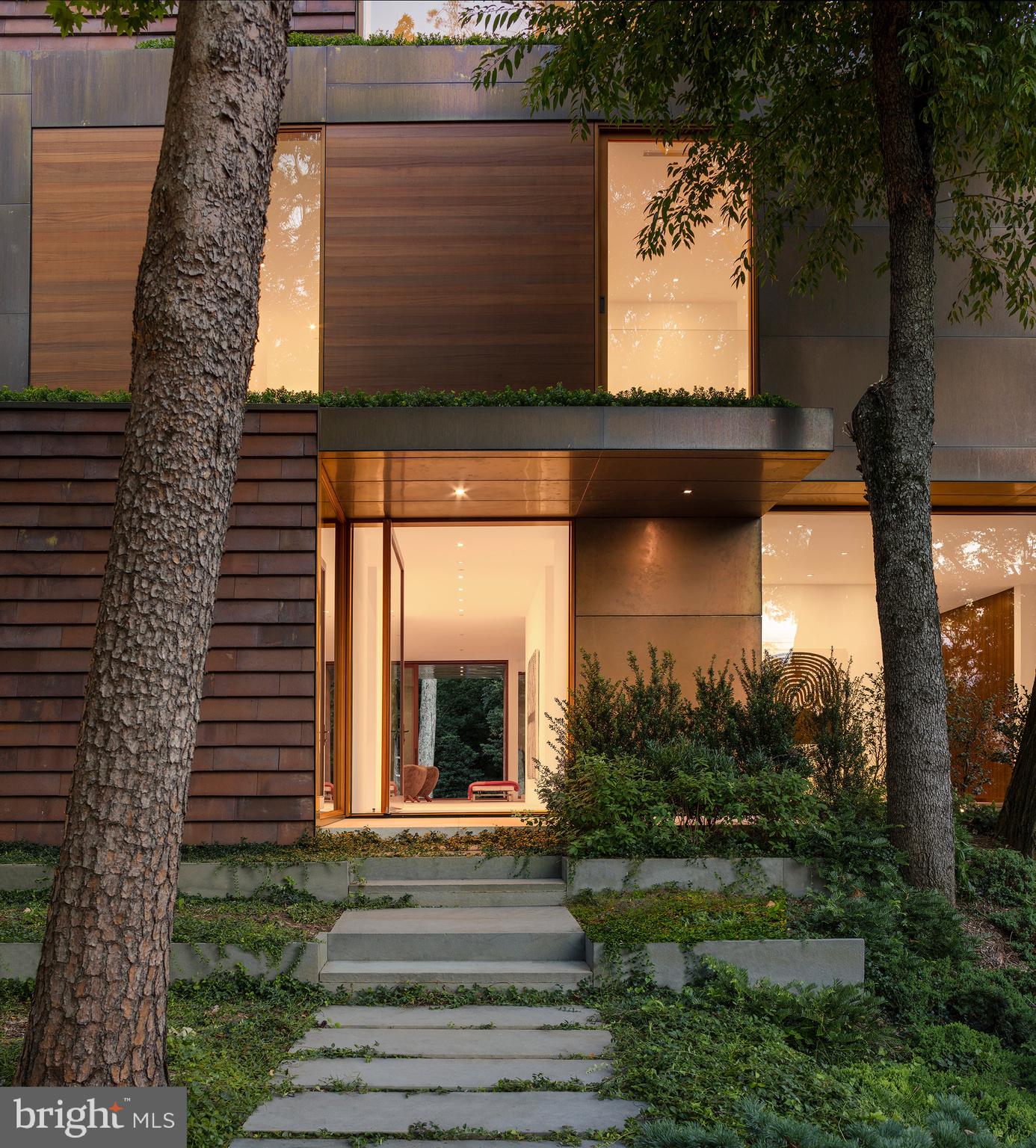 3131 Chain Bridge Road Northwest Washington, DC 20016 - Photo 4 of 54 a front view of a house with garden