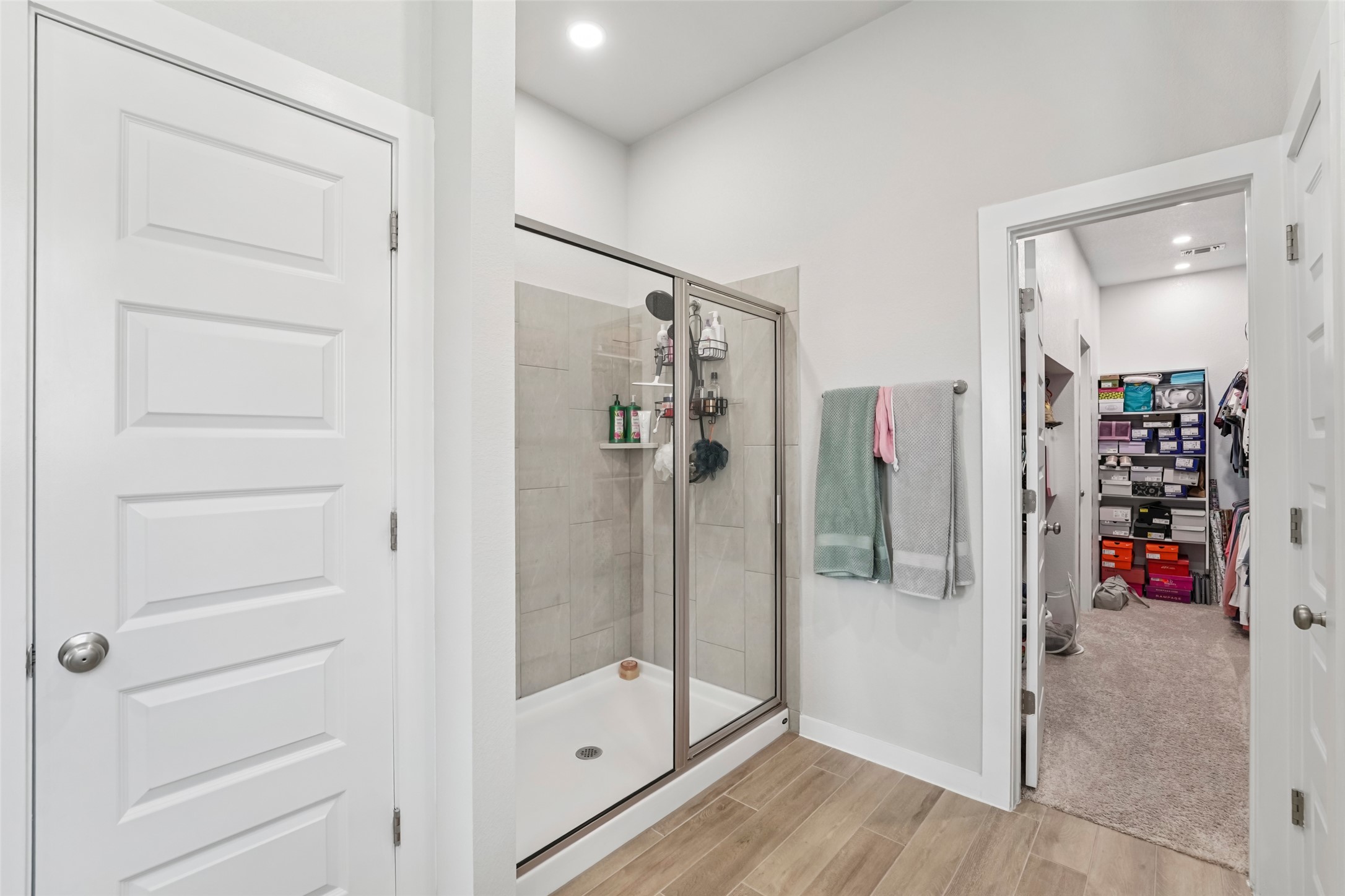 1108 Sweetspire Street Leander, TX 78641 - Photo 24 of 39 Full bathroom with a walk in closet, a stall shower, wood finished floors, and recessed lighting