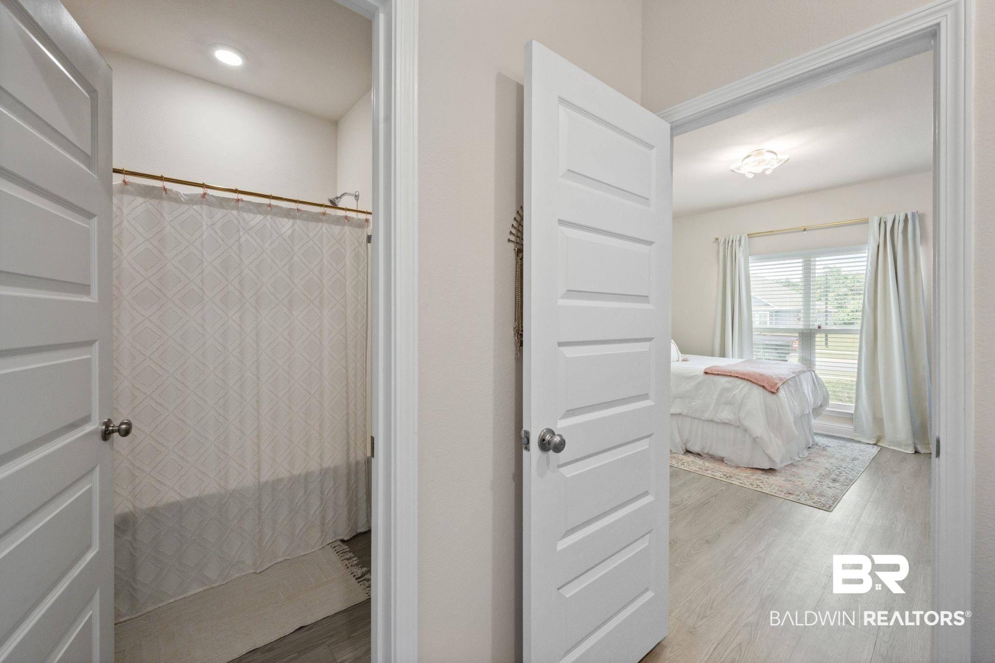 681 Calibre Street Fairhope, AL 36532 - Photo 10 of 56 Bathroom featuring wood-type flooring and curtained shower