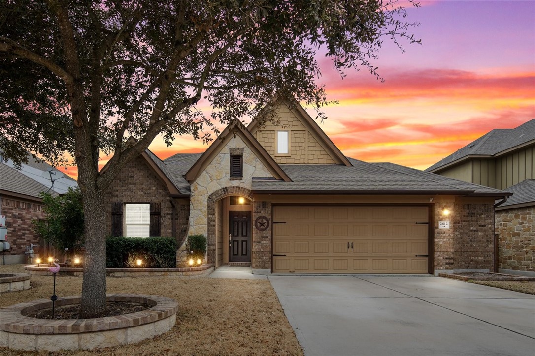 a front view of a house with a yard garage and fountain