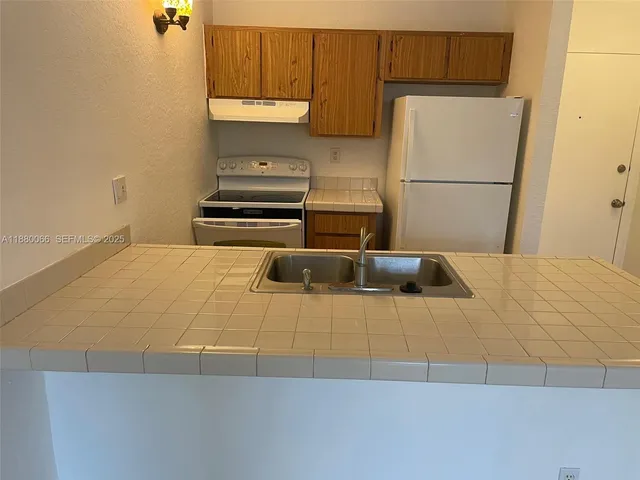 $1,440 | 2401 Riverside Drive, Unit 203B, Coral Springs, FL 33065