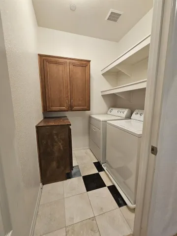 a room with a dryer and washer