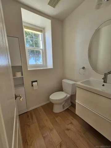 a bathroom with a toilet sink and mirror