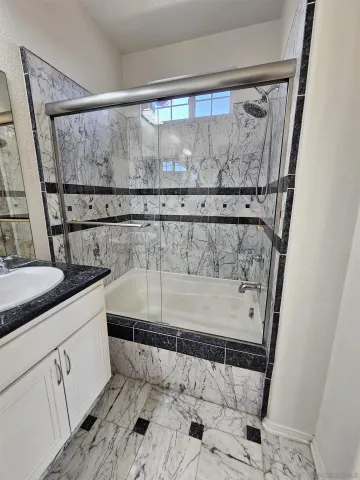 a bathroom with a shower and vanity