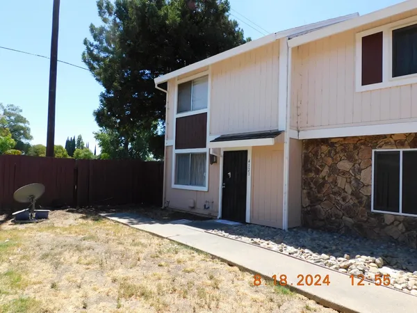 a backyard of a house with wooden fence