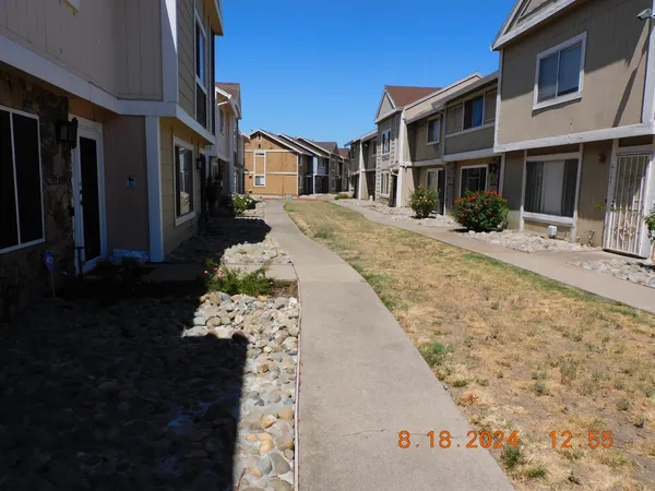 a view of a white house with a yard
