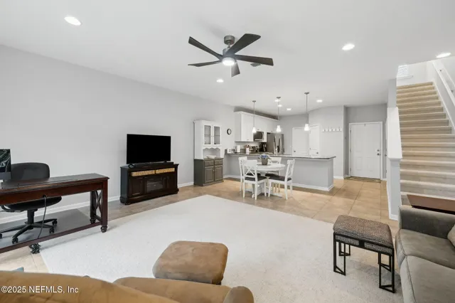 a kitchen with kitchen island granite countertop a sink a counter top space appliances and cabinets