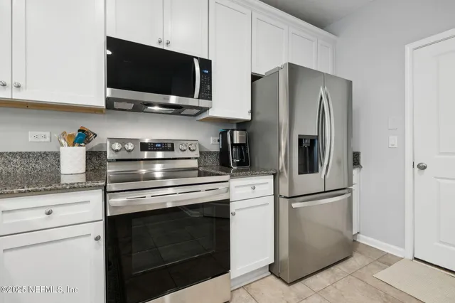 a stove top oven sitting inside of a kitchen
