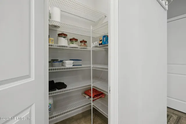 a living room with furniture a large window and a flat screen tv