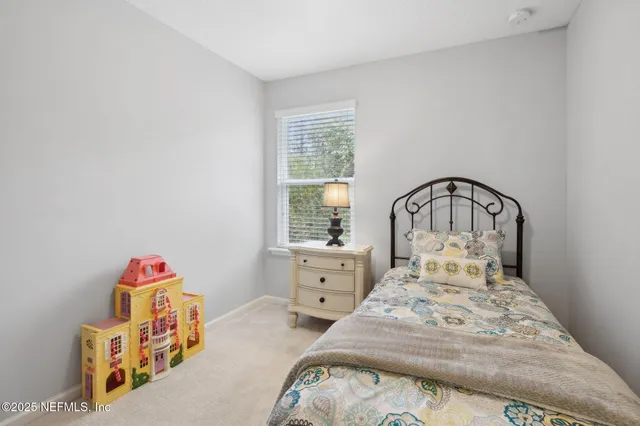 a bedroom with a bed and a ceiling fan