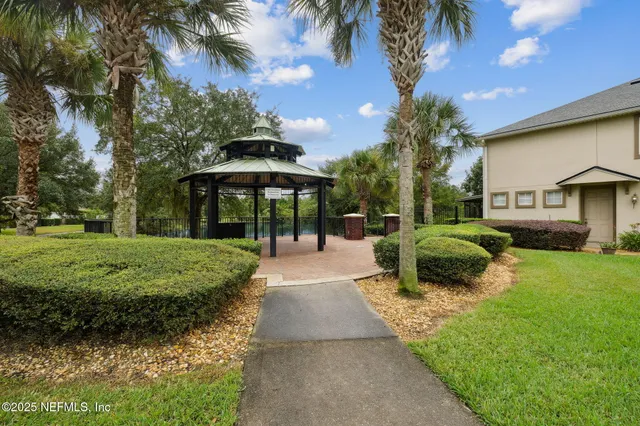 a view of a brick house with wooden fence