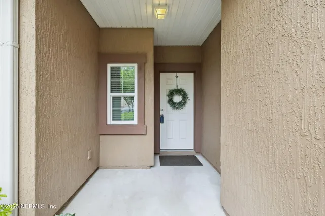 a view of a hallway with a livingroom and a livingroom with furniture