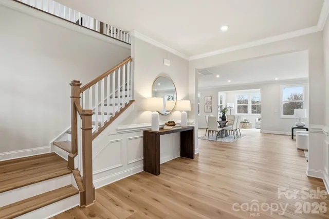 a large kitchen with stainless steel appliances a stove a sink a island with a dining table and chairs