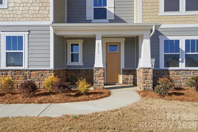 a view of living room kitchen and entryway