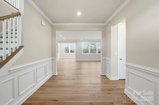 a kitchen with kitchen island white cabinets and stainless steel appliances