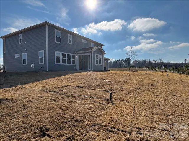 a living room with furniture a fireplace and a large window