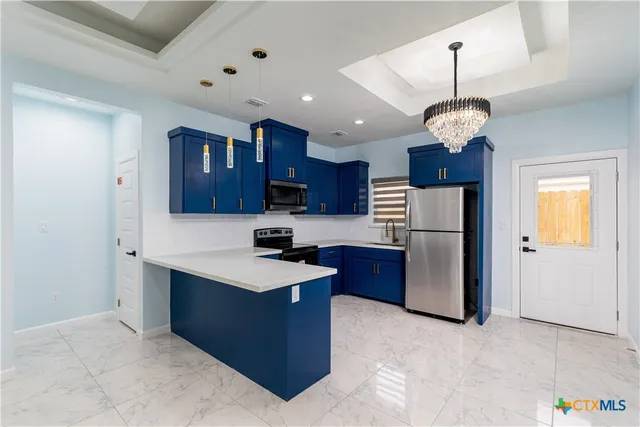 a kitchen with stainless steel appliances granite countertop a sink refrigerator and microwave