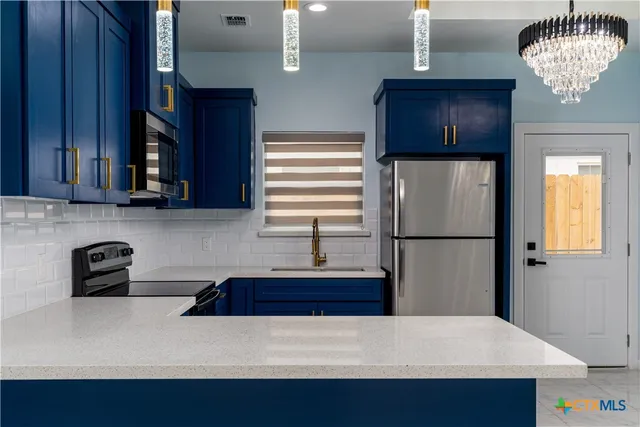 a kitchen with stainless steel appliances a refrigerator and a stove